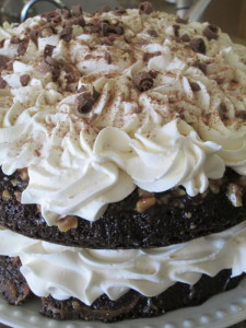 Repeat with second cake, putting it caramel side up on top of whipped cream covered cake, using piping bag to make swirls of cream. Covering the top layer, leave a little cake showing,  We want to show the delicious caramel pecans! Sprinkle top of cake with chocolate dust and chocolate curls.