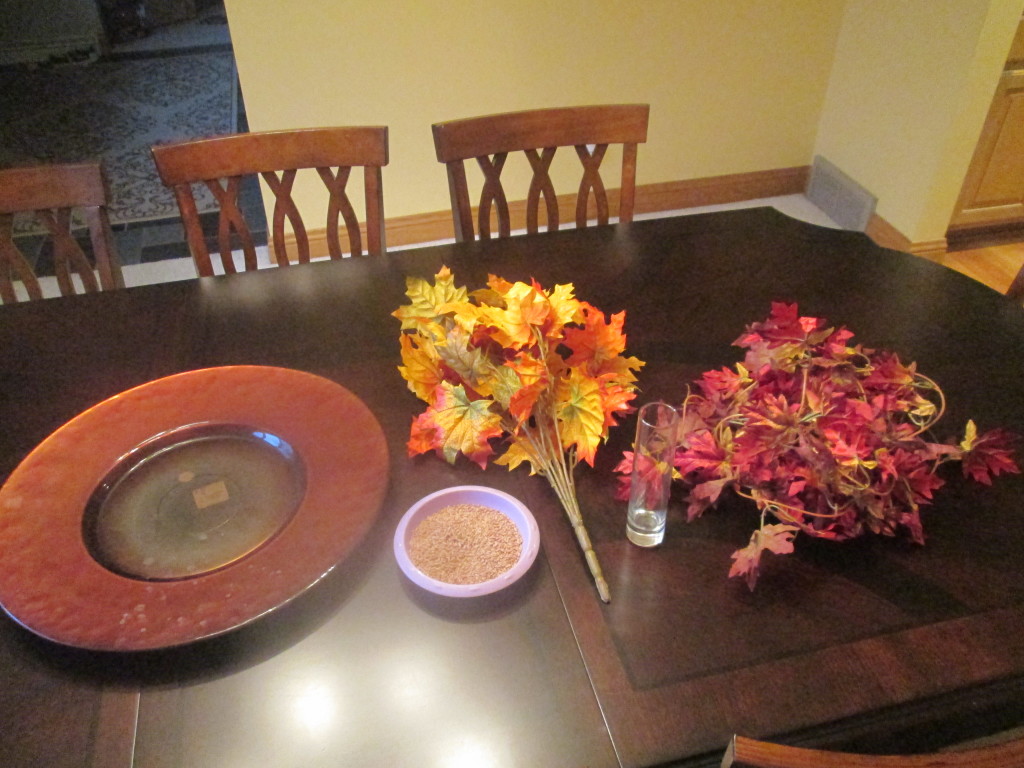I had some wheat, a large plate, a stemmed set of leaves, a small glass vase, and some leaf garland.