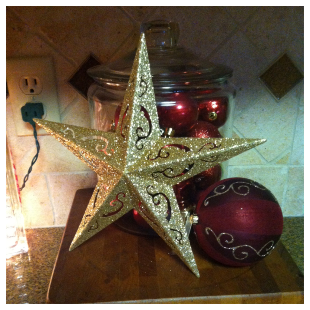 DOLLAR STORE DECORATIONS!!   The ornaments, the star and the big ornament ball are all from the dollar store! Well, everything but the jar.This little set up is in the kitchen.  I LOVE IT!