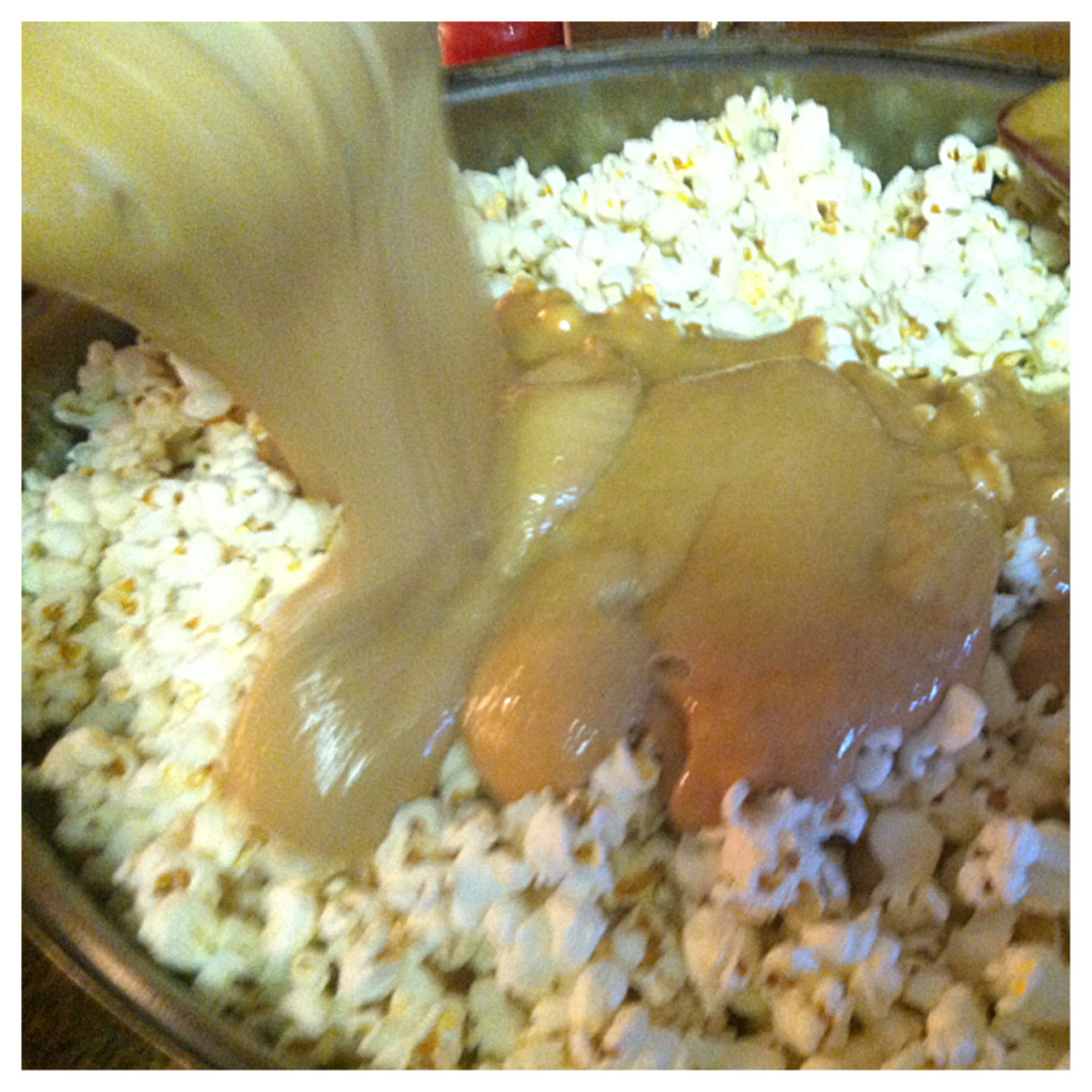 Pour over popcorn, fold into popcorn until all mixed.
